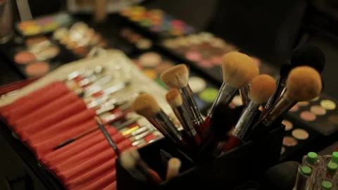 Stylist does makeup with professional cosmetics Stock Footage 127981733