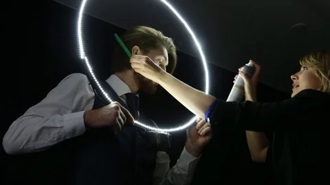 Stylist making final touch on bearded man hairstyle.  Stock Footage 75228693