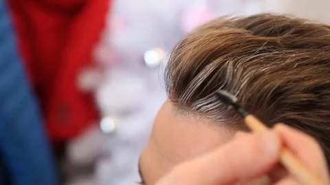 Stylist making final touch on young guy hairstyle.  Video stock 74190008