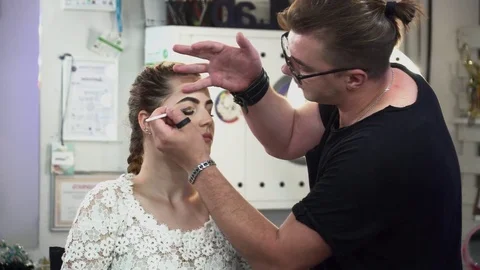Stylist making makeup for a bride in the studio Stock Footage 77237238