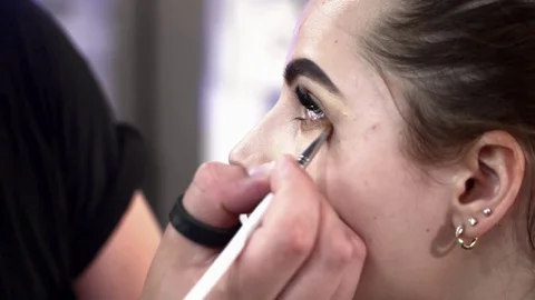 Stylist making makeup for a young bride closeup Stock Footage 77237486