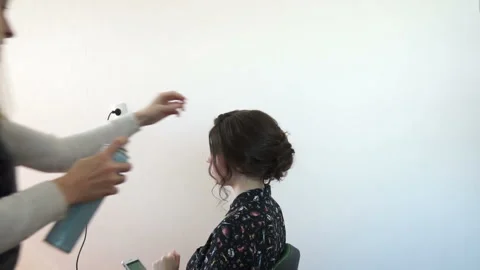 A stylist with a model on a white background Stock Footage 116553370