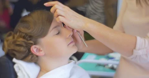 Stylist is Putting an Eyeshadow Making a Makeup Client Woman Model With New Stock Footage 56875495