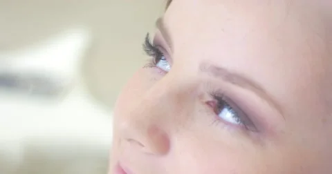 Stylist is Putting a Highlighter Under Model's Eye Model is Talking Smiling Stock Footage 56877190