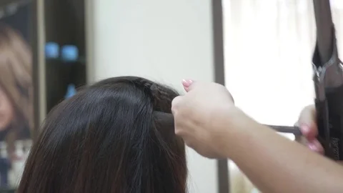 Stylist uses curling hair Stock Footage
