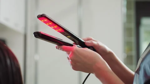 Stylist using lights, professional stylist applying led heat therapy, trained Stock Footage 323120630