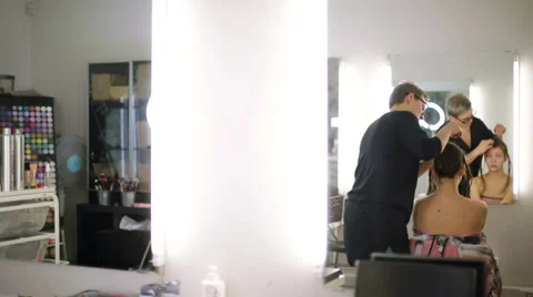The stylist works in the reflection of the mirror Video stock 68648374