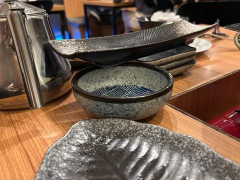 Stylized arrangement of Asian tableware set on a warm-toned 写真素材