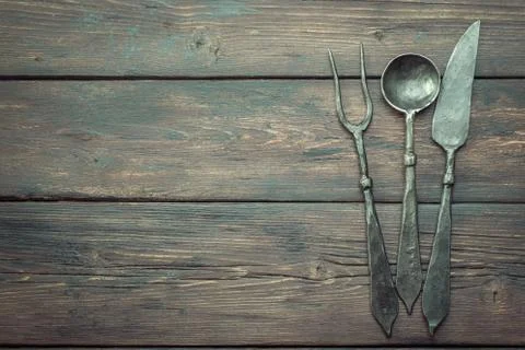 Stylized cutlery on rustic table above Stock Photos