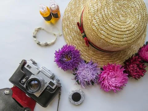 Stylized feminine flatlay with camera, hat, bunch of aster, bracelet mock up  Stock Photos