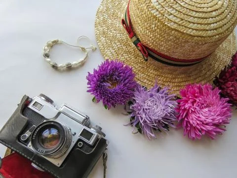Stylized feminine flatlay with camera, hat, bunch of aster, bracelet mock up  Foto stock