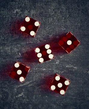 Stylized playing dice on dark background, shallow depth of field, top view, c Stock Photos