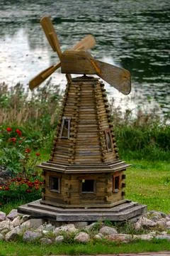 Stylized replica of a small mill made of wooden planks. Stock Photos