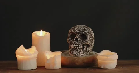 Stylized skull with candles on the table Stock Footage 140880846