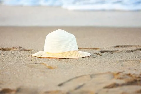 A stylized summer setting featuring a straw hat, sunglasses, and a striped towel Stock Photos