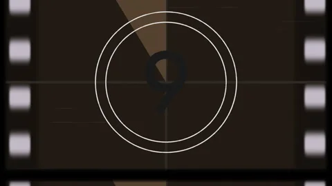 Stylized text sweeping in film countdown graphic on brown screen, with rotating Video stock 311450624
