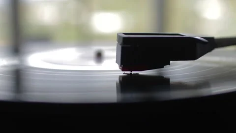 Stylus close-up on a spinning vinyl record. A vintage turntable playing  Stock Footage 320025142