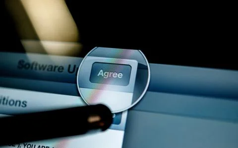 Stylus pressing Agree button on display Stock Photos
