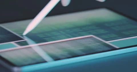 Stylus is used to move around the tablet screen with windows and lines of code Stock Footage 248206477