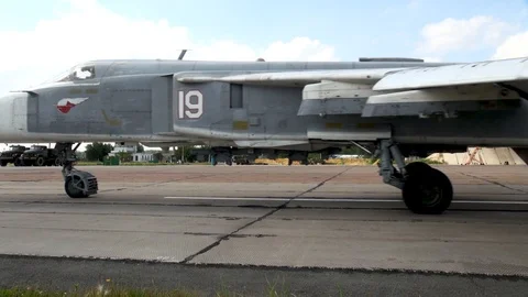 Su-24 (Fencer) - supersonic bomber moves along taxiway past airplanes. Stock Footage 122817341