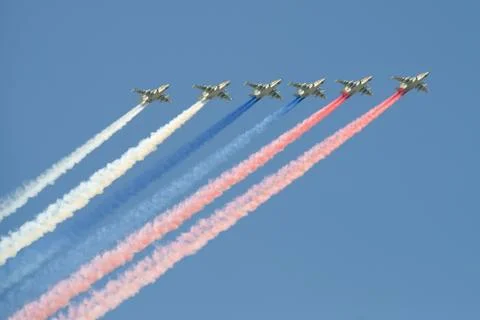The SU-25 attack planes with smokes of flowers of a flag of Russia Stock Photos