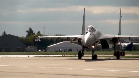 Su-27SM aircraft with thrust vector quickly turns in parking lot near runway. 動画素材 118647568