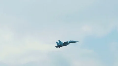 An su-35 Fighter Jet flying high above the clouds. Russian fighter flies a Stock Footage 73684754
