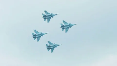 An su-35 Fighter Jet flying high above the clouds. Russian fighter flies a Stock Footage 73684833