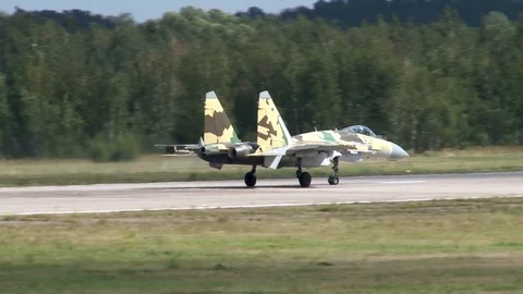 Su-35 multi-role fighter (Flanker-E) steers along runway towards parking lot. Stock Footage 115696257