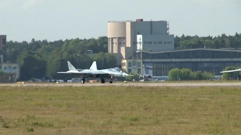 Su-57 fifth-generation fighter on  runway makes turn toward take-off. Stock Footage 115395147