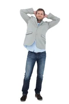 Suave man in a blazer with hands behind head looking at camera Stock Photos