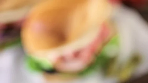Sub sandwich with fresh vegetables, lunch meat and cheese on hoagie roll. Stock Footage