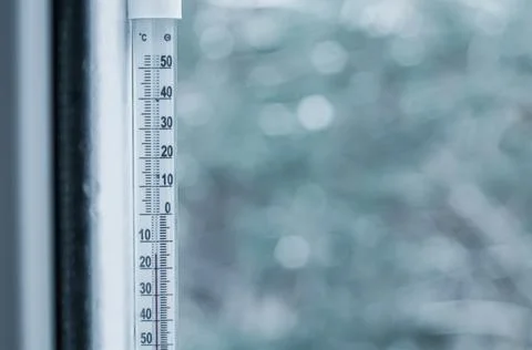 Sub-zero temperature on the thermometer outside the window. Winter. Selective Stock Photos