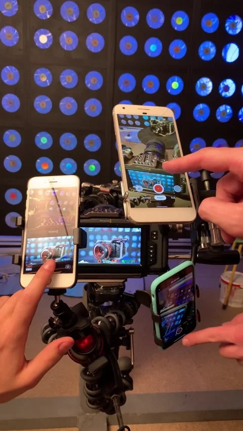 A subject filming a movie camera on a table shot by three iphone smartphones. Stock Footage 233489028