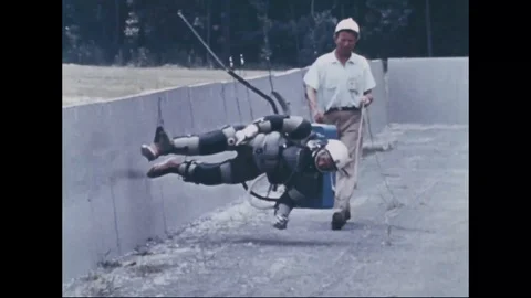 Subject fitted with harness practices reduced gravity simulator - 1960 Stock Footage 105754465