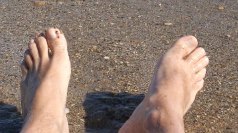 Subjective shot of bare feet on a beach - 4K Video stock 80239611