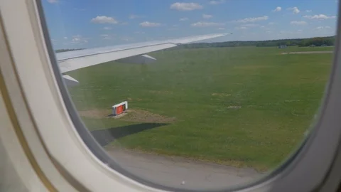 Subjective shot from the window of a moving airplane in a green environment  Stock Footage 112115877