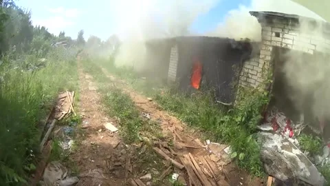 The subjective view of a firefighter while extinguishing fires in garages Stock Footage 295982147