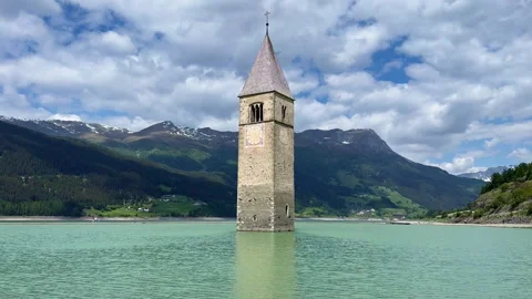 Submerged Bell Tower at Lake Resia under Moving Summer Clouds Stock Footage 342155448