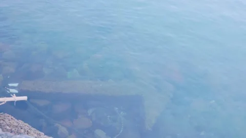 Submerged vessel anchor visible through clear sea water on shallow seabed Stock Footage 340749806