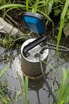 Submersible drainage pump with float switch in muddy irrigation water Stock Photos
