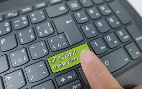 Submit online form key on a gray keyboard. Finger pressing key Stock Photos