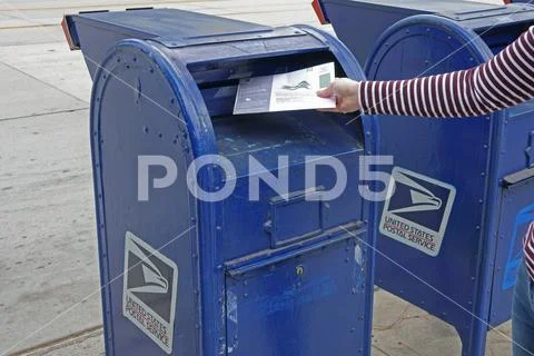 Submitting A Vote By Mail Ballot In A Blue USPS Mailbox Stock Image #141881606