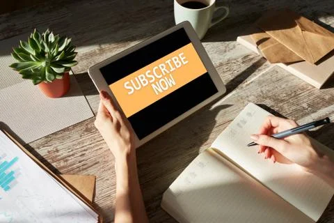 Subscribe button on device screen. Internet and digital marketing concept. Stock Photos