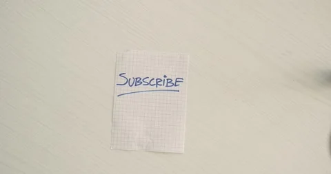 Subscribe  - a man's hand presents a word on the note Stock Footage 267086882