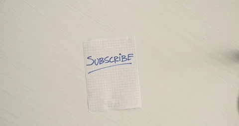 Subscribe  - a man's hand presents a word on the note Stock Footage 267086942