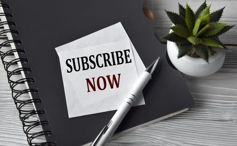 SUBSCRIBE NOW - words in a white notebook against the background of a black.. Stock Photos