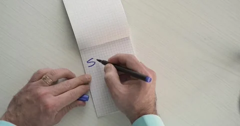 Subscribe  - this word is written on the sheet by a man's hand Stock Footage 267085285
