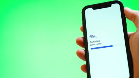 Subscription cancellation stuck at 70 percent on a smartphone against green Stock Footage 342940445
