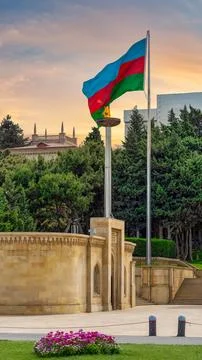 Substantial flame in front of the Azerbaijani flag, which flies proudly in Baku Stock Photos
